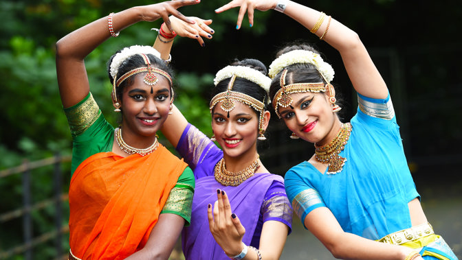 Three dancers in traditional dress art Glasgow Mela