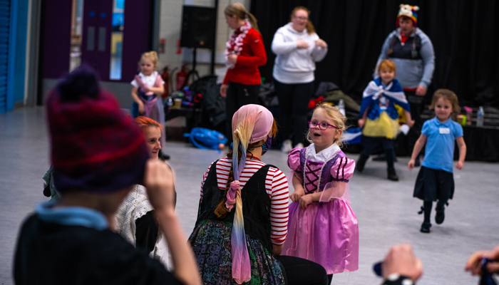 Young children get ready in costume to perform a play