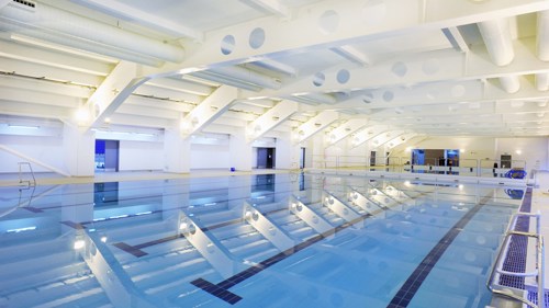 A large indoor swimming pool with swimming lanes