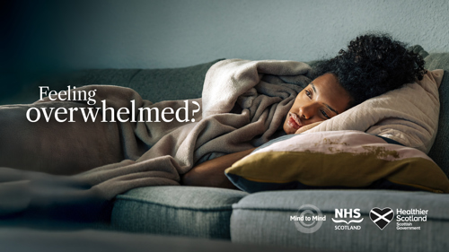 A person lying on a sofa covered in a blanket with text Feeling overwhelmed?
