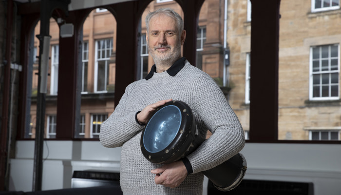 Conductor Paul MacAlindin poses with a drum 