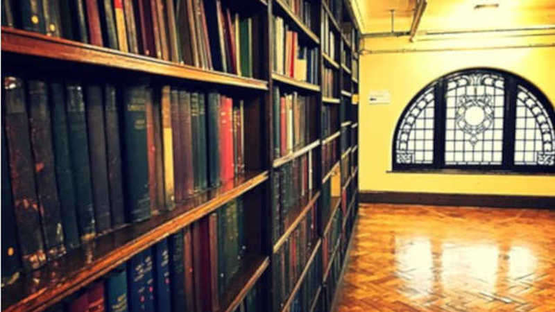 Photograph of shelves within a library.