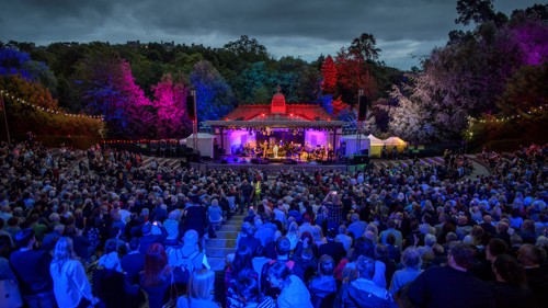 An audience enjoy a concert at a 1920s bandstand and amphitheatre