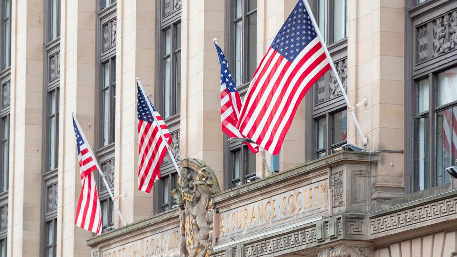 United States of America flags hanging from the side of a building in Glasgow