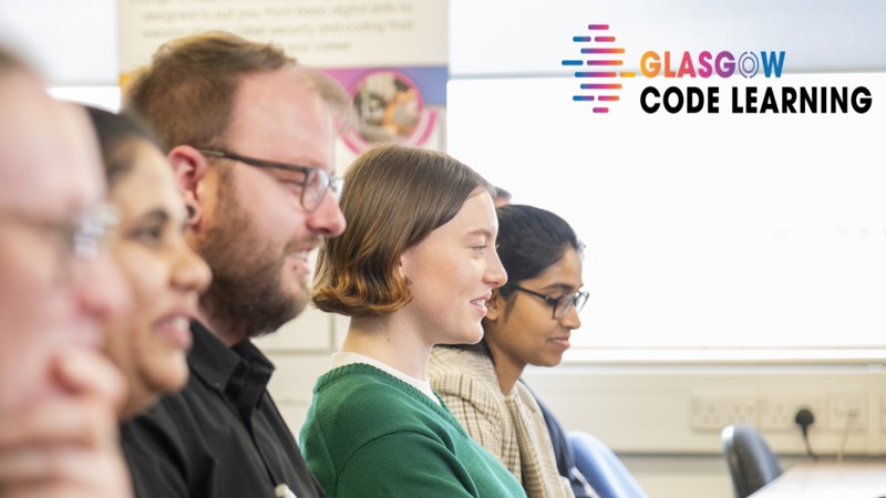 People working and smiling at computers