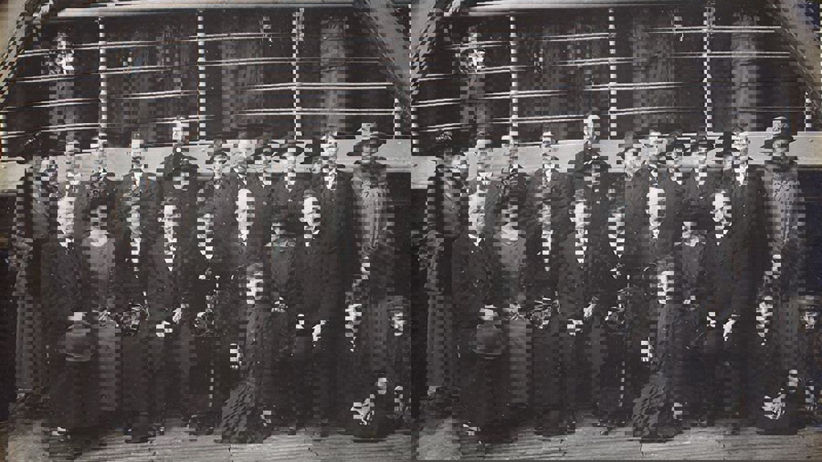 A black and white photo of several Belgian Refugees on a SS Khyber ship with members of the Belgian Relief Committee in 1919