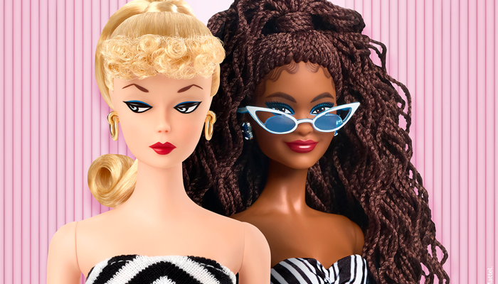 Two Barbie dolls side by side. One has blonde hair in curls and a ponytail, gold hoop earrings, and a black-and-white striped strapless dress. The other has long brown braided hair, blue earrings, white cat-eye sunglasses, and a black-and-white patterned strapless dress.