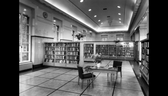 Black and white photograph of a library  with shelves of books