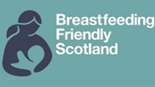 Breastfeeding Friendly Scotland logo with graphic of a person with long hair holding a baby
