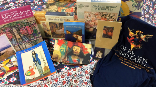 A colourful selection of merchandise including postcards, books and jigsaws featuring objects from the Collection