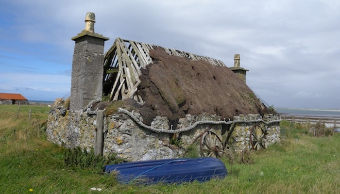 Cottage with damage to roof and walls