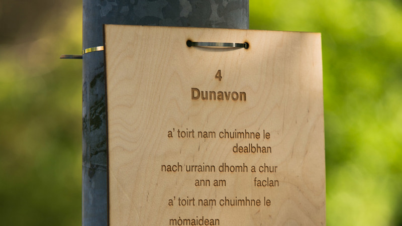 A signpost made of wood with a qr code links people to poetry