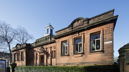 Exterior of a stone-built Victorian library on a clear winter day