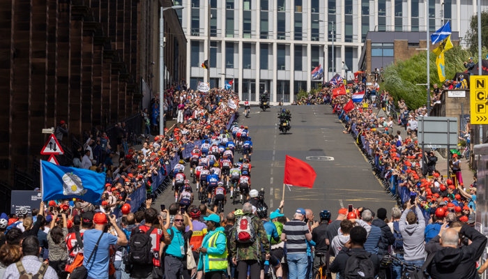 Professional cyclists racing up a hill on Montrose Street in Glasgow