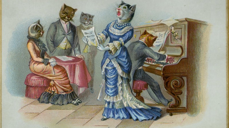 A Christmas card with a group of cats singing round a piano