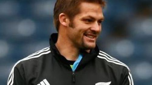 A close up image of the All Black Captain wearing a black and white tracksuit top, looking to his left.