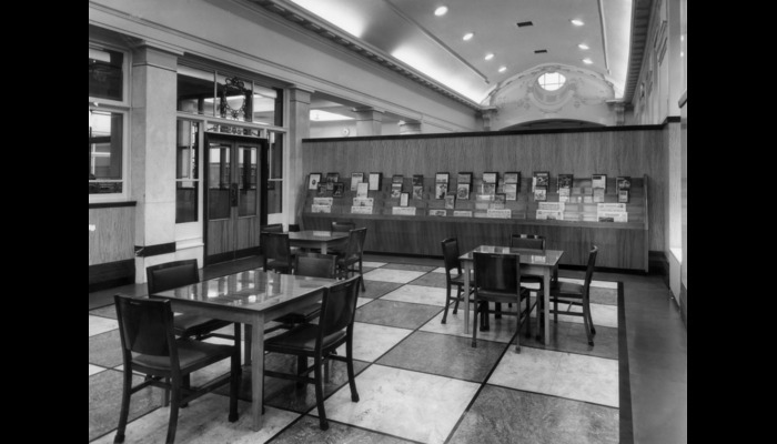 Black and white photograph of a library  with shelves of books