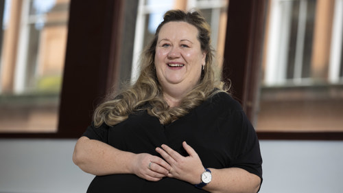 A head and shoulders portrait of a smiling woman