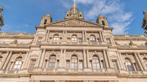 The front of an 1800s building beneath a blue sky