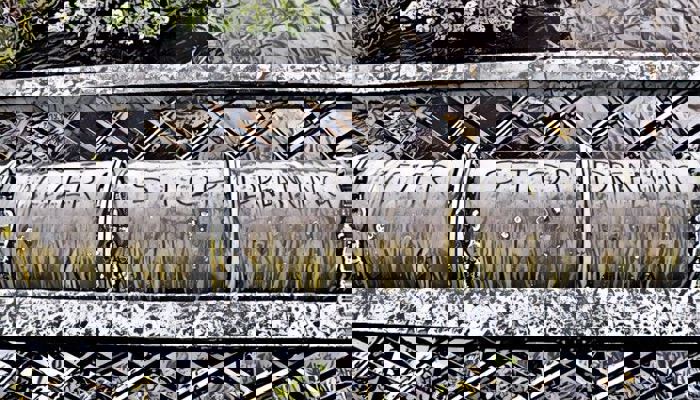 An image of artist work. It shows a large pipe with the words never stop dreaming.